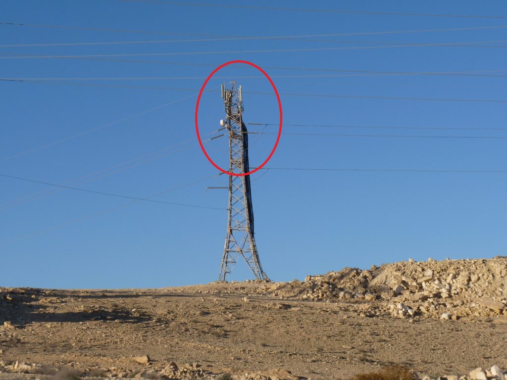 cell phone antennas on top of a power line post